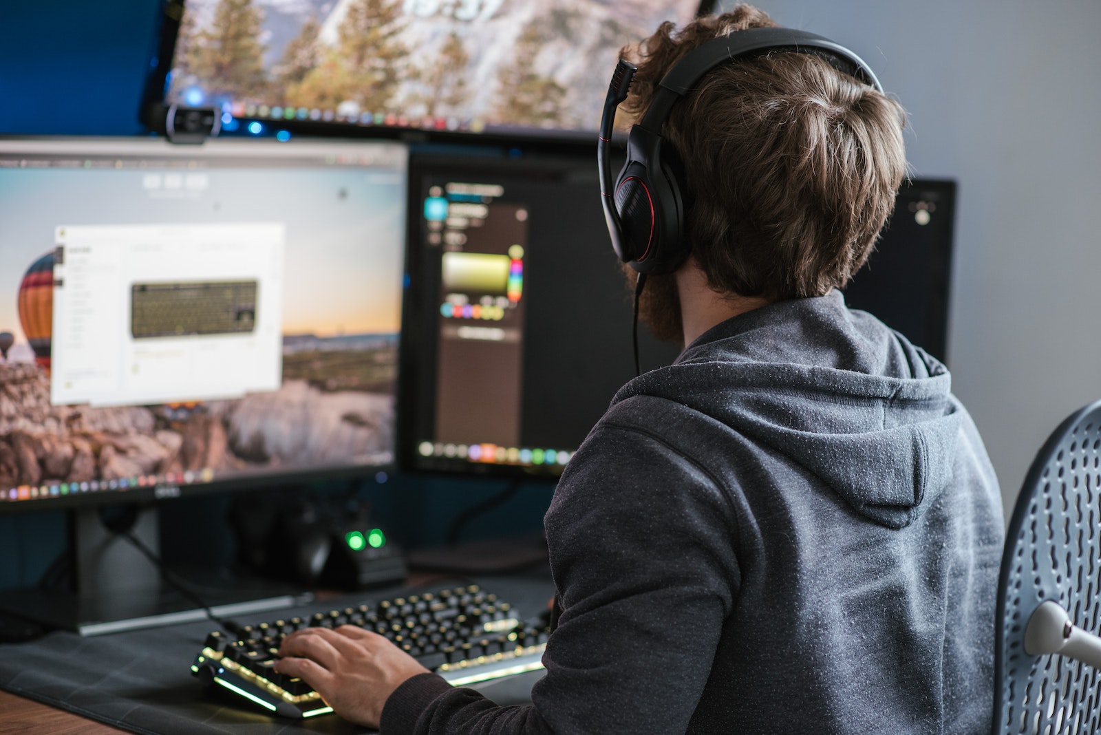 Unrecognizable man working on computer at home